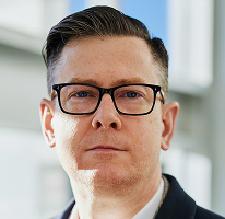 Portrait of Alexander Hughes, CEO and executive of a crypto trading company